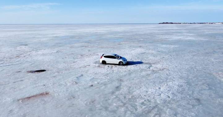 Abandoned car retrieved from ice off Nova Scotia shore by helicopter, snowmobiles – Halifax