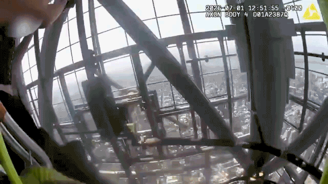 Two people scale Empire State Building in New York City