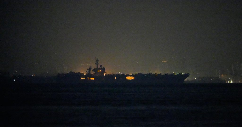USS Lincoln sails past Singapore on its way to the Middle East after grueling 9-month deployment