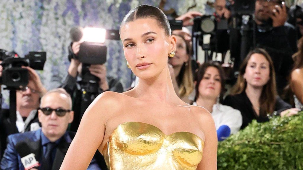 Hailey Bieber poses in yellow bikini and Rhode eye patches on Instagram